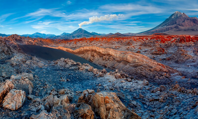 Mount Licancabur Volcano and colorful mineral deposits. Viewed from Valle de la Luna in the Atacama Desert region of northern Chile, South America.