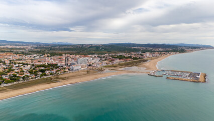 Aerial drone photo of the coastline and town centre of Comarruga in Spain