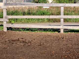 Rural idyll. Corral for horses. Wooden fence in the village.