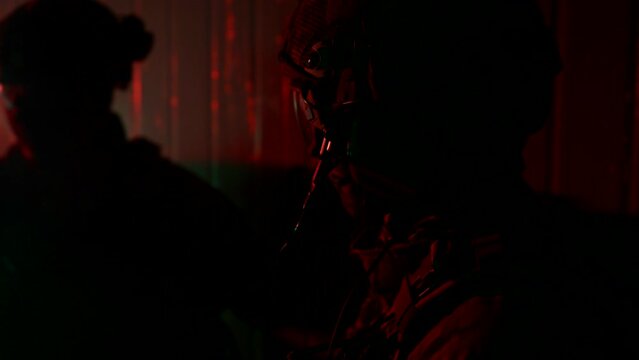 soldiers of tactical unit discussing plan of attack, counterterrorist operation, silhouettes in dark