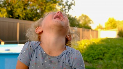 A child is crying on the street. Selective focus.