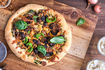 A homemade gourmet mushroom and shallots pizza ready for sharing. - obrazy, fototapety, plakaty