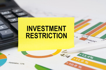 On business reports there is a calculator and a sign with the inscription - investment restriction