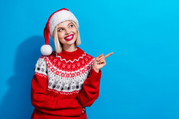 Portrait of lovely positive girl look indicate finger empty space newyear proposition isolated on blue color background