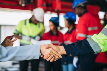 Team engineers and foreman stack hand and shake hands to show success at factory machines. Worker industry join hand for collaboration.