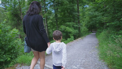 Mother and Child Walking Hand in Hand in Nature Trail, Enjoying Weekend Hiking Activity....