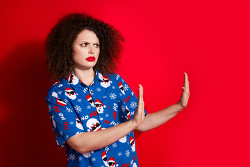 Photo portrait of lovely young lady hands showing stop gesture dressed stylish blue print x-mas garment isolated on red color background