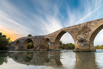 Fototapeta premium The historical Aspendos Bridge over Koprucay at sunrise in Antalya Turkey