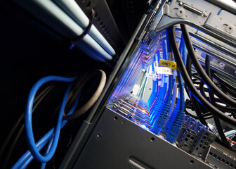 close up of network cables connected to server racks in data center room