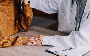 Female doctor in white coat holding hand of senior patient, giving help, comfort, psychological...