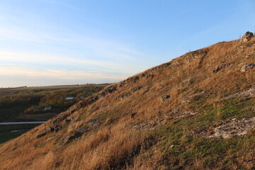 A hill with a road and a car on it