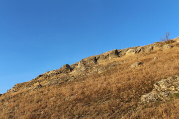 A hill with a hill and blue sky