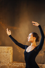 Portrait of an elegant ballerina dancer wearing black dress with long sleeves