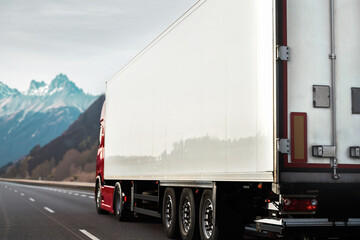 Cargo Semi Truck in the Mountains. Delivery freight truck on the Europe motorway. Global delivery...