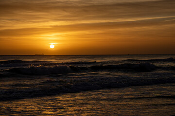 Fototapeta premium Sunrise over the Mediterranean in Miramar, Spain, with a ship visible on the horizon