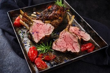 Traditional grilled rack of lamb with paprika and herbs served as close-up on a rustic metal tray