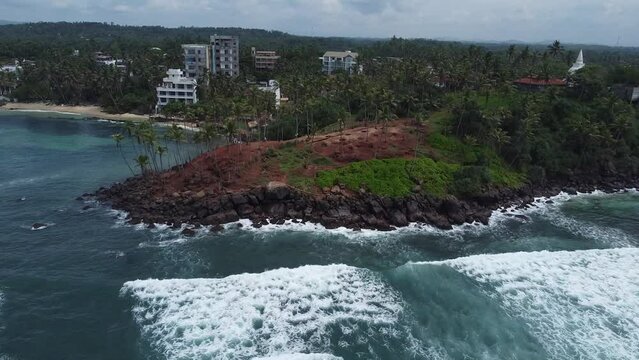 Aerial top view of Scenic Coconut tree hill in Mirissa, Sri Lanka