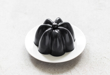 Black Matcha Cream Pudding on a plate. Close-up