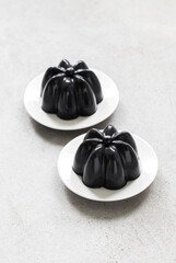 Vegan Black Matcha Cream Pudding on a plate. Close-up