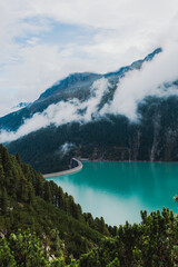 Nestled serenely amidst the rugged peaks of the majestic mountains, this pristine alpine lake...
