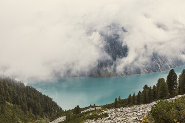 Nestled serenely amidst the rugged peaks of the majestic mountains, this pristine alpine lake...