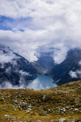 Nestled serenely amidst the rugged peaks of the majestic mountains, this pristine alpine lake...