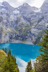 Fototapeta na wymiar Oeschinensee, often referred to as Oeschinen Lake, is a picturesque alpine lake nestled in the Swiss Alps.