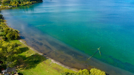 Aerial view of Lake Bracciano, originally also called Lake Sabatino. It is a lake of volcanic and tectonic origin, located in the metropolitan city of Rome and surrounded by the Sabatini Mountains.