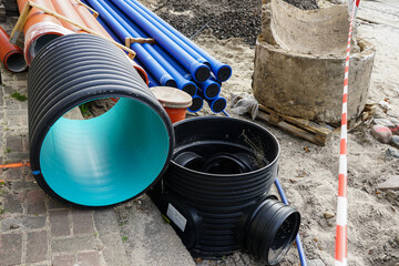 Replacement of water supply and sewer pipes, dirty old pipes next to new modern plastic pipes