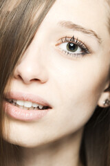 close up studio face portrait of a beautiful brunette girl with happy positive expression looking at camera...