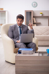 Young male employee working from home