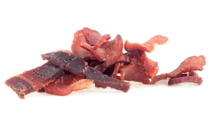 Portion of sliced and dried meat isolated on a white background. Pile of pork jerky pieces. - obrazy, fototapety, plakaty
