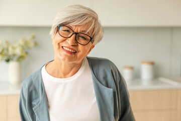 Portrait of confident stylish european middle aged senior woman. Older mature 60s lady smiling at home. Happy attractive senior female looking camera close up face headshot portrait. Happy people - obrazy, fototapety, plakaty