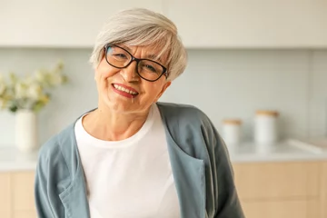 Fotobehang Portrait of confident stylish european middle aged senior woman. Older mature 60s lady smiling at home. Happy attractive senior female looking camera close up face headshot portrait. Happy people © Юлия Завалишина