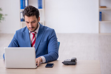 Young male employee working in the office