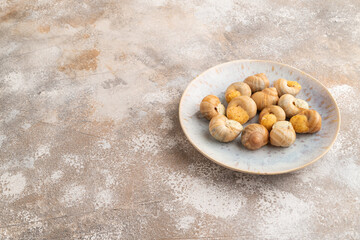 Grape (Burgundy) snails with butter and cheese on brown concrete, top view, copy space.