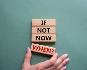 If not now when symbol. Concept words If not now when on wooden blocks. Beautiful grey green background. Businessman hand. Business and If not now when concept. Copy space.