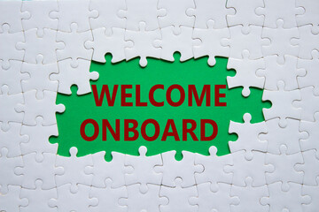 Welcome onboard symbol. Concept words Welcome onboard on white puzzle. Beautiful green background. Business and Welcome onboard concept. Copy space.