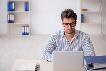 Young male employee working in the office