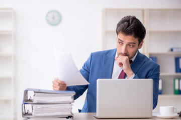 Young male employee working in the office