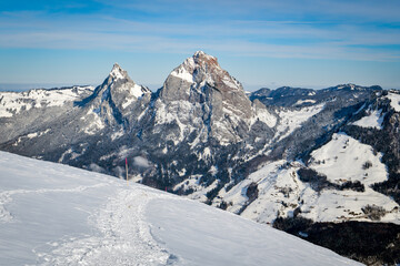 Fototapeta na wymiar Walking trail on snow with beatutiful views on mountains