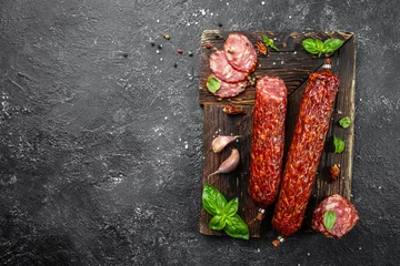 Foto op Canvas Salami sausage slices on a wooden board. banner, menu, recipe place for text, top view © Надія Коваль