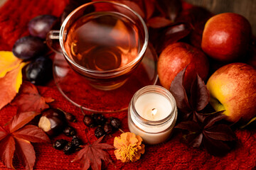 Autumn arrangement of pumpkins, apples, tea and candles