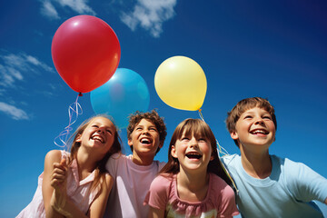 Fototapeta na wymiar Happy cheerful children with bunch of colorful balloons over the blue sky