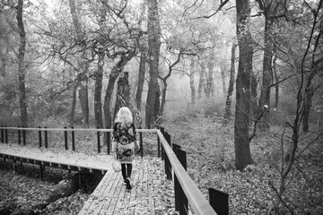 Woman walk on the footpath at mysterious forest.