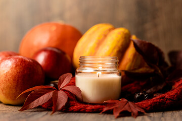 Burning candle next to tea and autumn fruits. Autumn Composition