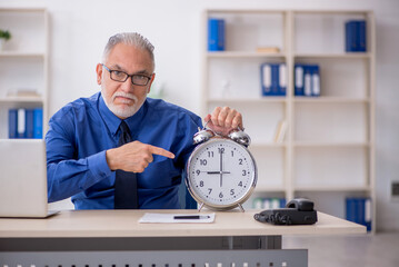 Old male employee in time management concept
