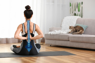 Young woman practicing yoga at home. Concept of healthy spine - obrazy, fototapety, plakaty