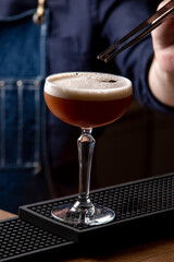 Bartender preparing a cocktail in a restaurant, close-up