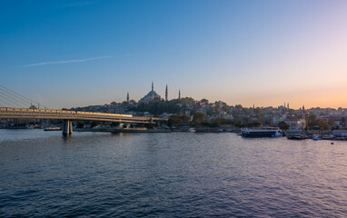 Obraz premium Captured the enchanting night ambiance of Istanbul's iconic Karakoy Pier, where the shimmering lights and bustling ferry lines create a magical scene of istanbul
